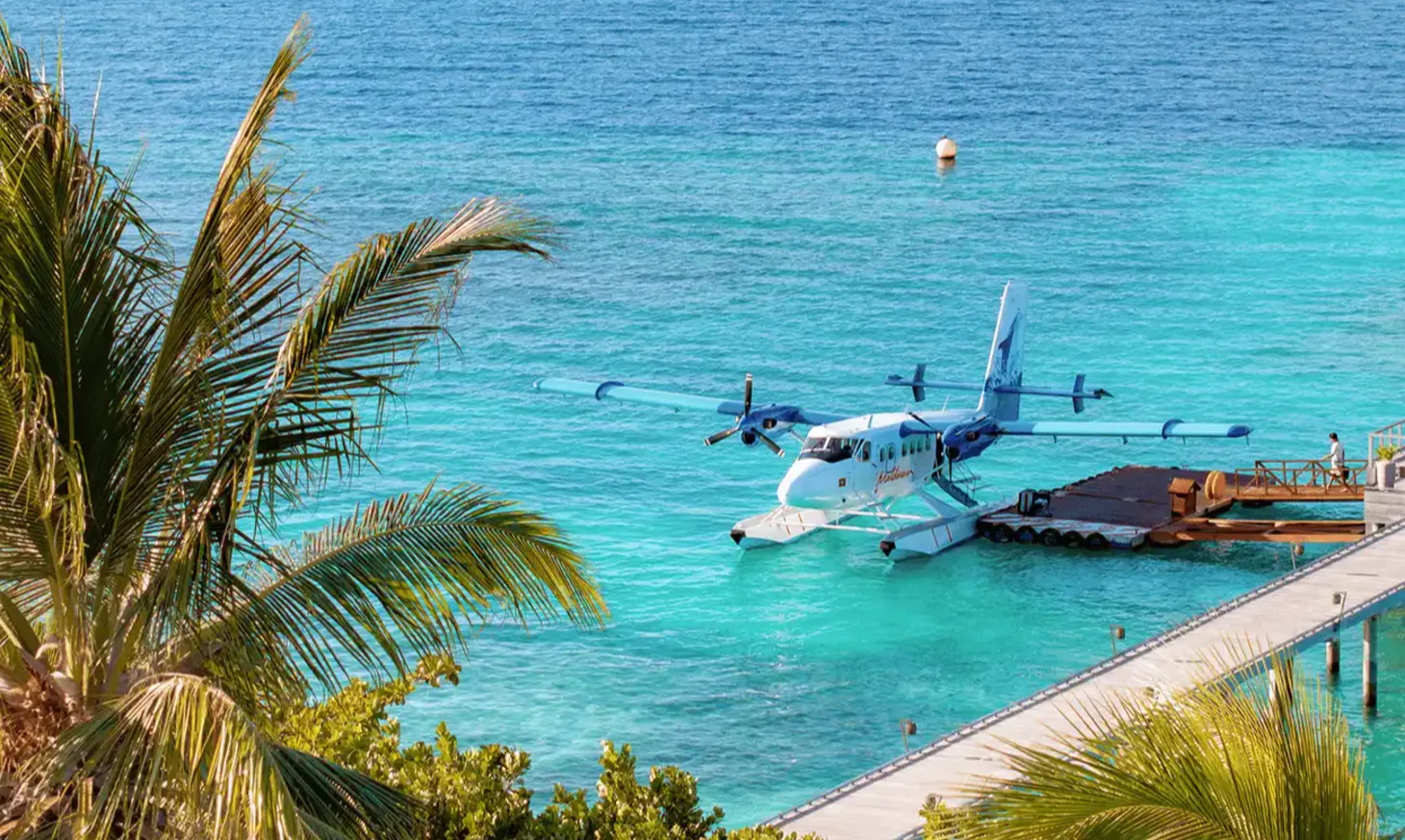 Seaplane docked at Vakkaru Maldives resort surrounded by turquoise water