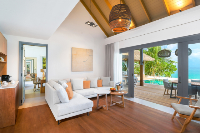 Three-bedroom beach pool retreat indoor living room overlooking the ocean