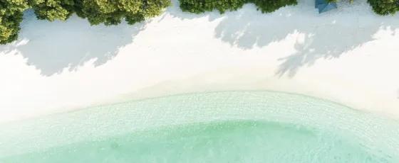 Tropical beachscape view at Vakkaru Maldives with white sand and clear ocean
