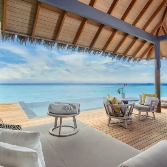 Overwater pool villa at Vakkaru Maldives with ocean and lagoon views and luxury seating