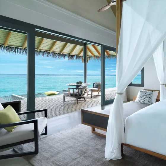 Overwater villa at Vakkaru Maldives with ocean and lagoon views and luxury seating