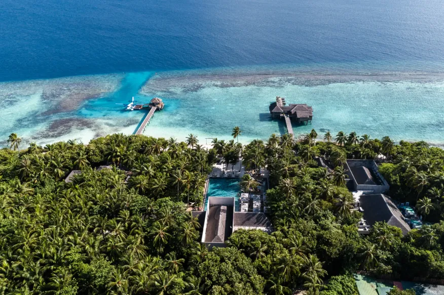 Aerial view of Vakkaru Maldives showcasing its island location amid turquoise waters and coral atolls.