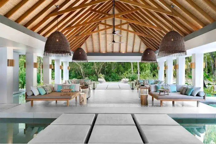 Cabana restaurant lounge at Vakkaru Maldives with thatched ceilings and wicker lights.