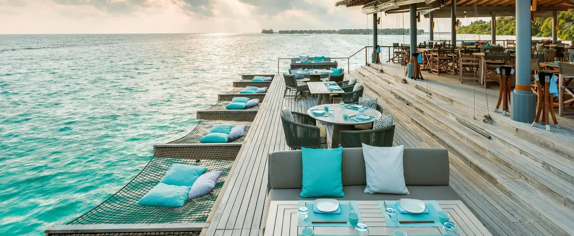 Lagoon Bar at Vakkaru Maldives with overwater hammocks and ocean seating