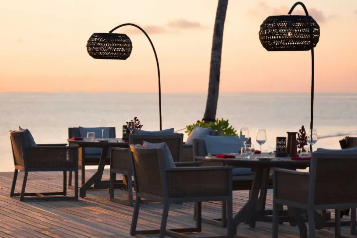 Open-air grill restaurant at Vakkaru Maldives with elegant oceanfront seating.