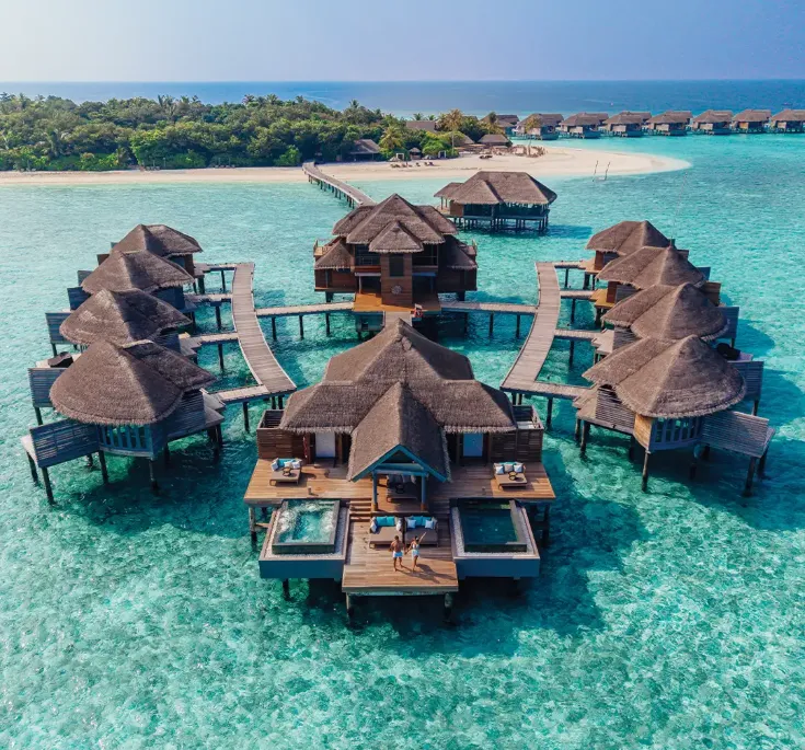 Overwater residence at Vakkaru Maldives resort featuring private infinity pools over turquoise water