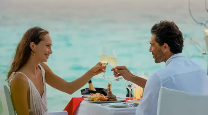 Couple enjoying a romantic private sandbank dining experience at Vakkaru Maldives