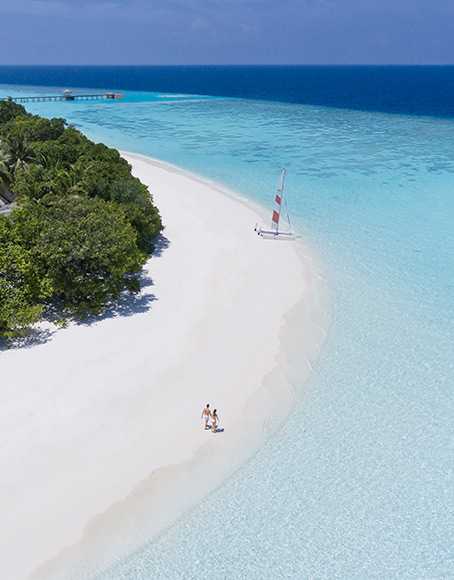 A couple walking along the beach