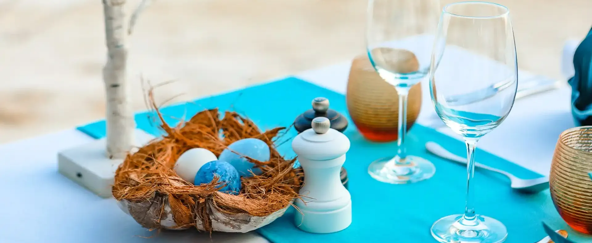 Decorative coconut egg arrangement on a styled table setting.