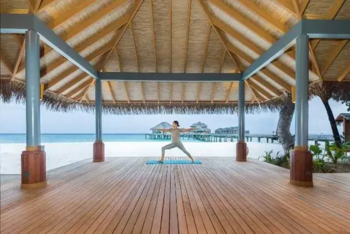 Beachfront yoga pavilion at Vakkaru Maldives overlooking the ocean.