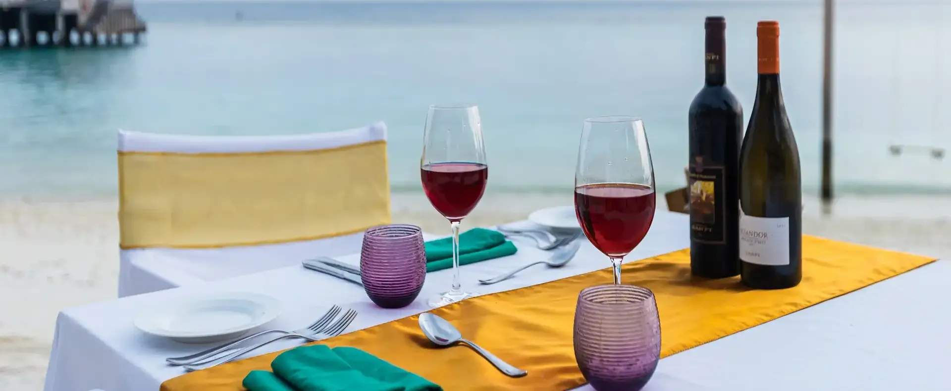 Intimate beachfront dining at Vakkaru Maldives with fine wines and uninterrupted ocean views at sunset.