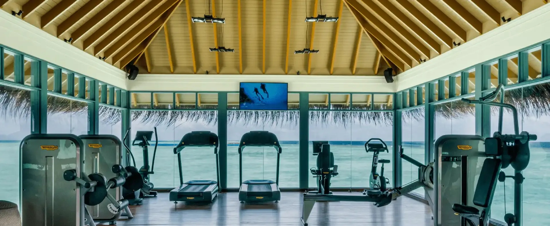 Overwater gym with ocean-view fitness equipment.