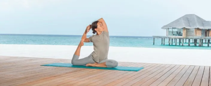 Overwater yoga and wellness pavilion at Vakkaru Maldives resort in the lagoon