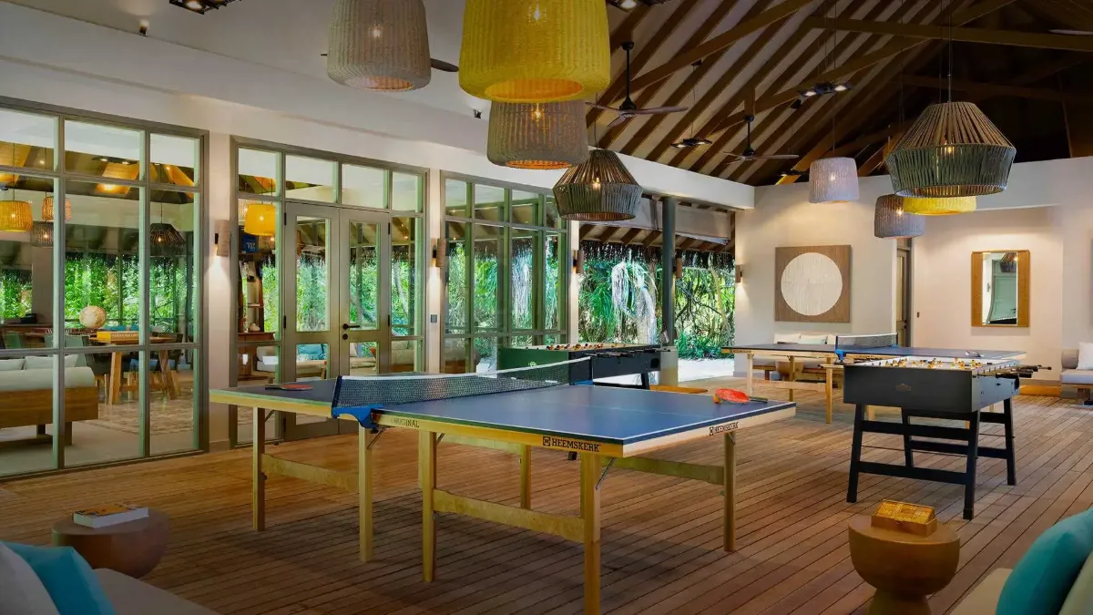 Recreation room at Vakkaru Maldives featuring table tennis and panoramic views of tropical island landscapes.