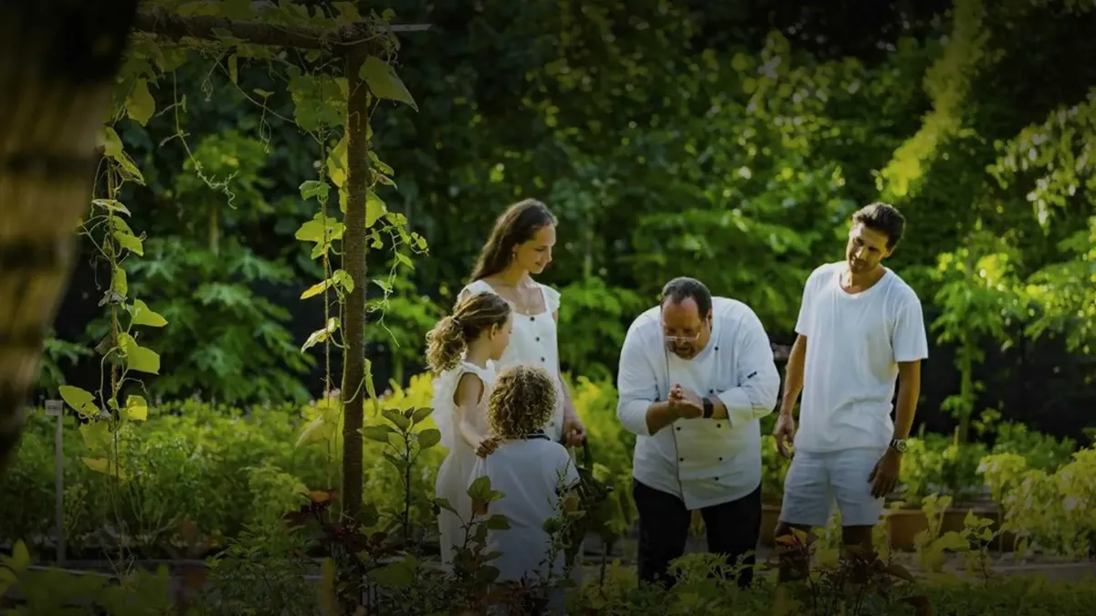 Chef and family exploring the organic garden at Vakkaru Maldives and discovering fresh island ingredients.