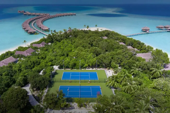 Outdoor sports fields at Vakkaru Maldives Residence offering football, badminton, and beach volleyball in a scenic island setting.