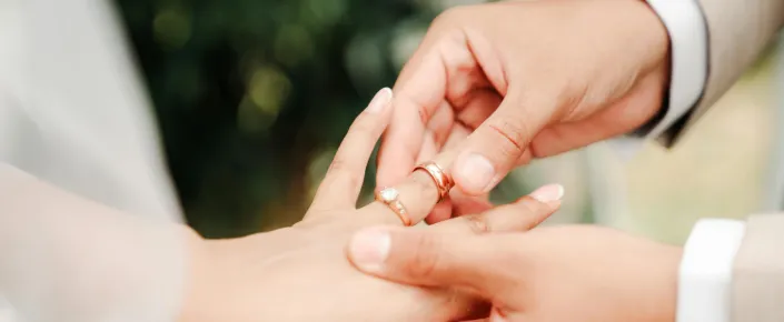 Couple exchanging wedding rings during a romantic island destination wedding ceremony at Vakkaru Maldives