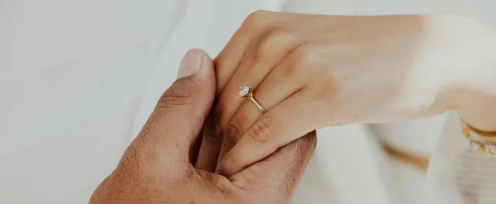 Couple celebrating a romantic proposal with a diamond engagement ring at Vakkaru Maldives