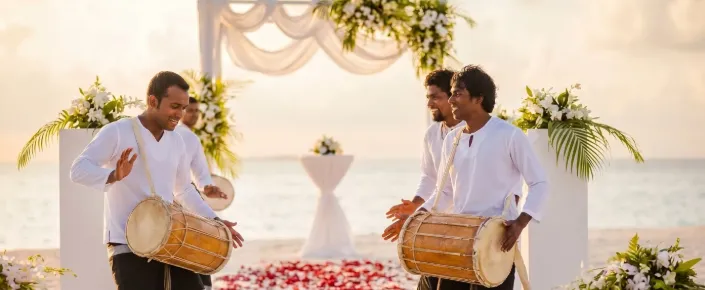 Traditional Poruwa wedding ceremony on the beach at Vakkaru Maldives with drummers